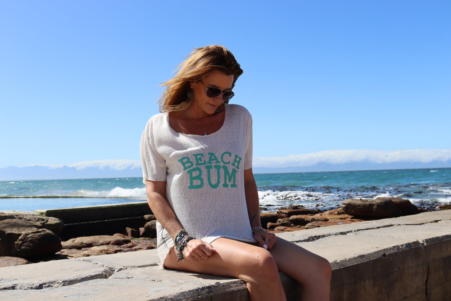 White beach bum with teal lettering