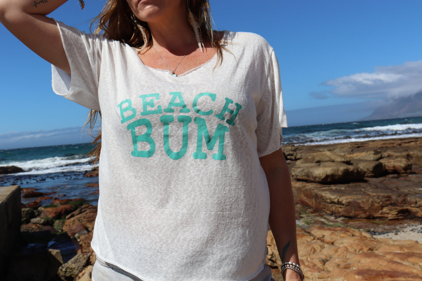 White beach bum with teal lettering